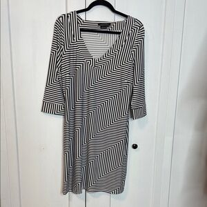 princess polly baby blue dress BCBG Max Azria New York Ready to Wear Autumn Winter Black and brown silk  dress brown belt over a black thin top long sleeves Stock Photo